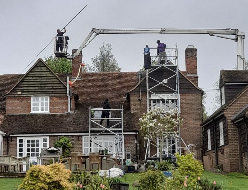The Roof Moss Cleaners using cherry picker and scaffolding to clean roof safely and professionally in Hartley Wintney, Hampshire
