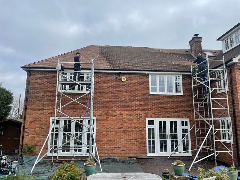 Roof cleaning carried out safely from scaffold towers by The Roof Moss Cleaners in Hartley Wintney